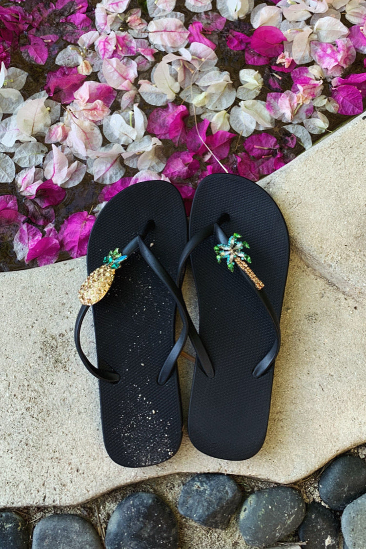 Black flip-flops with decorative charms