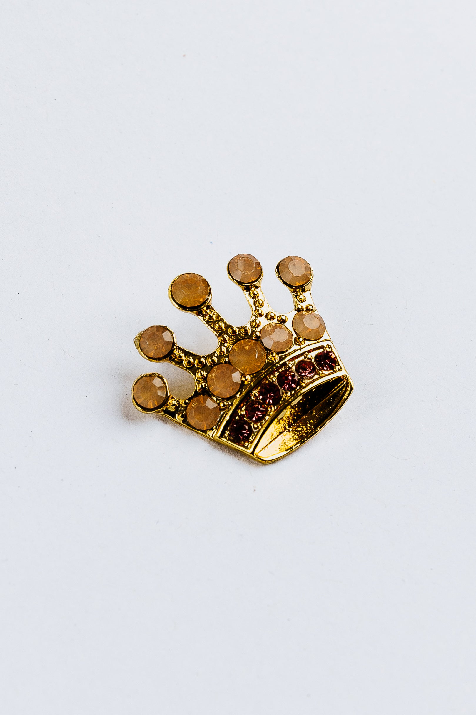 Gold crown-shaped charm with gemstones