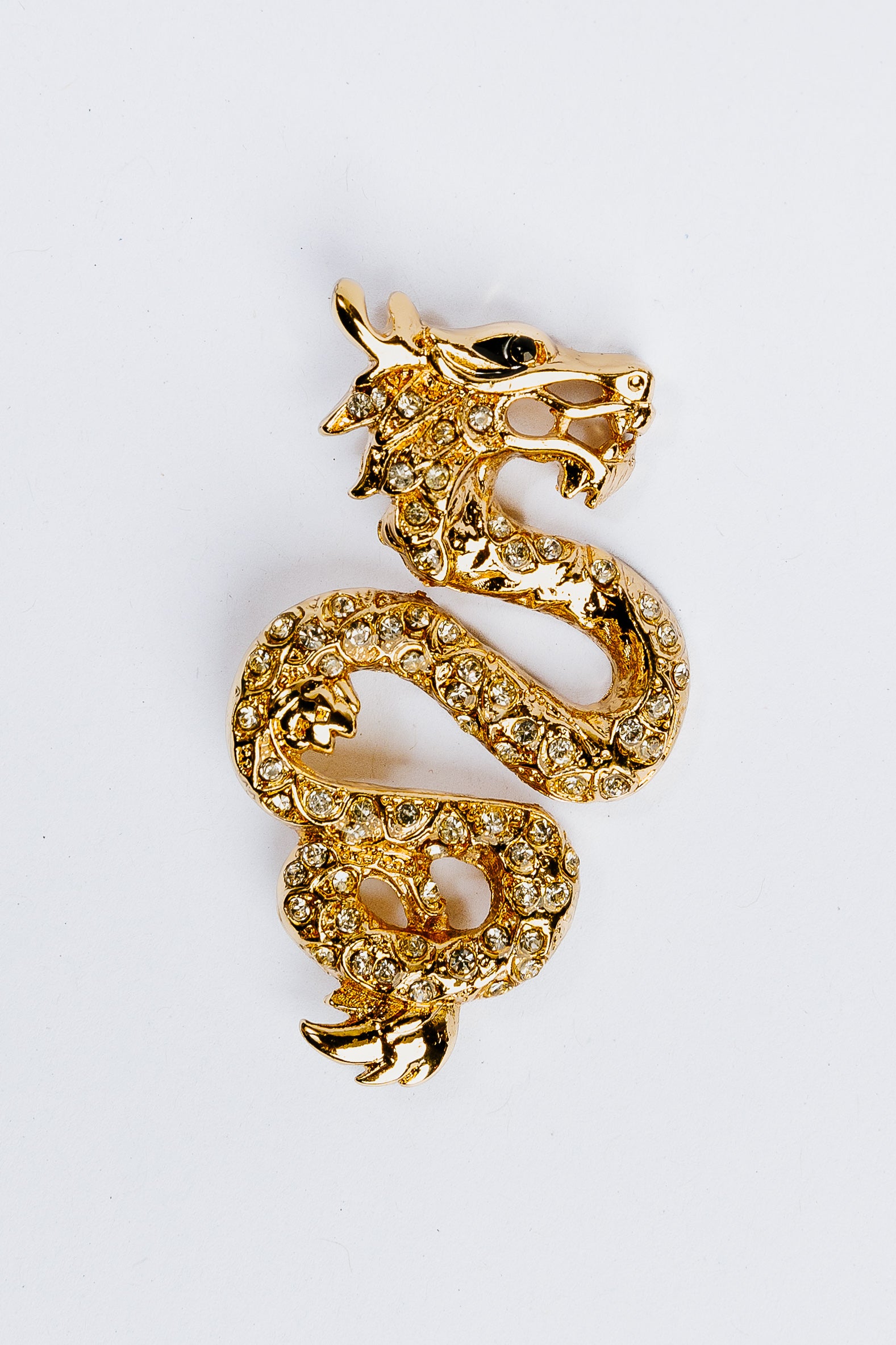 Gold dragon-shaped charm with gemstones