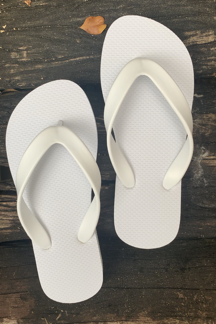 Pair of white flip-flops for kids