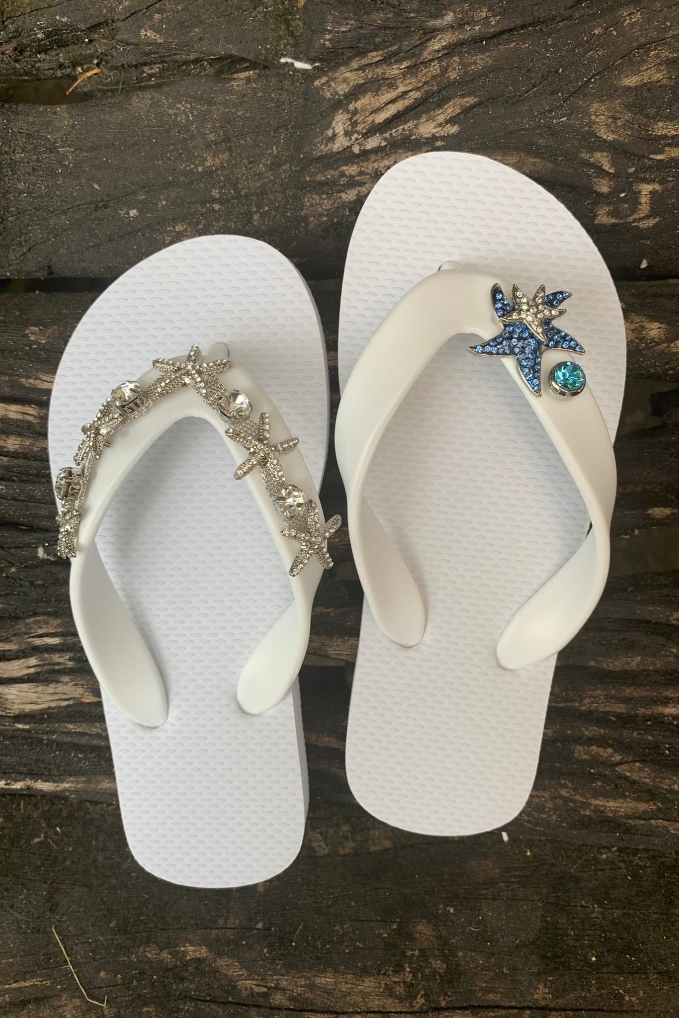 White flip-flops with decorative starfish, blue gemstone charms on straps