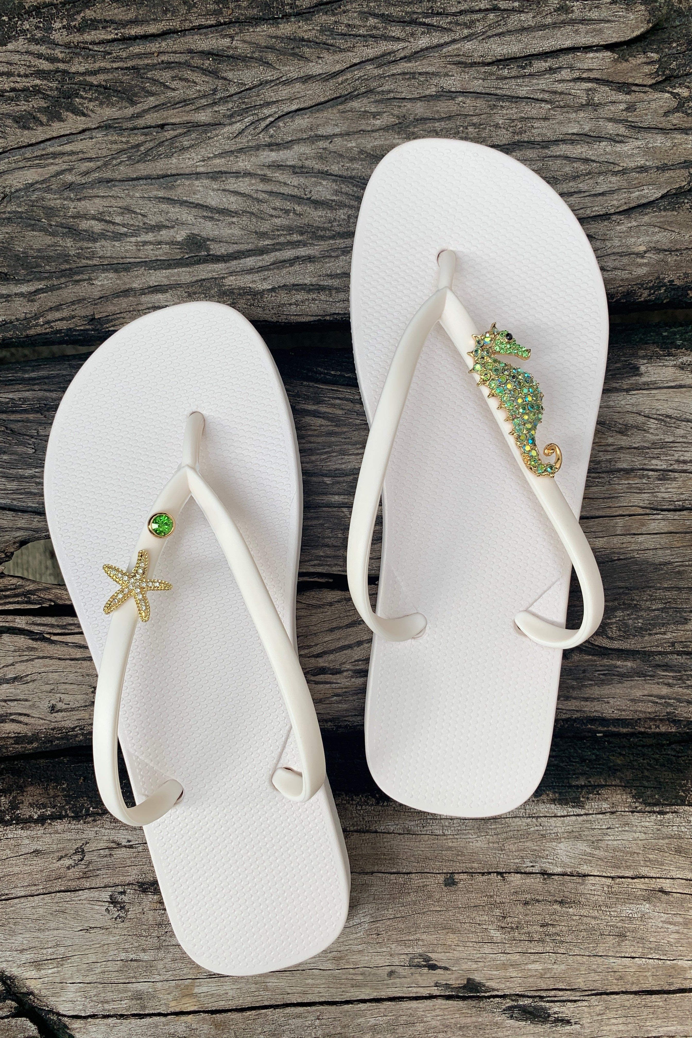 White flip-flops with decorative charms