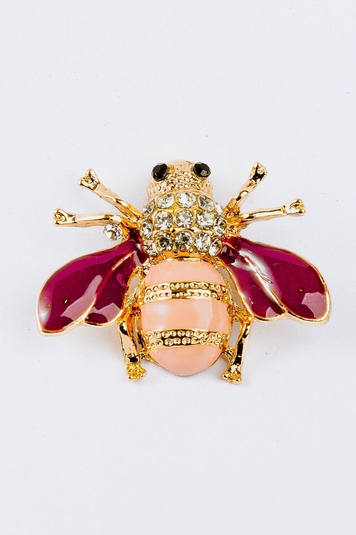 Pink  bee-shaped charm with magenta wings and pink body on a white background