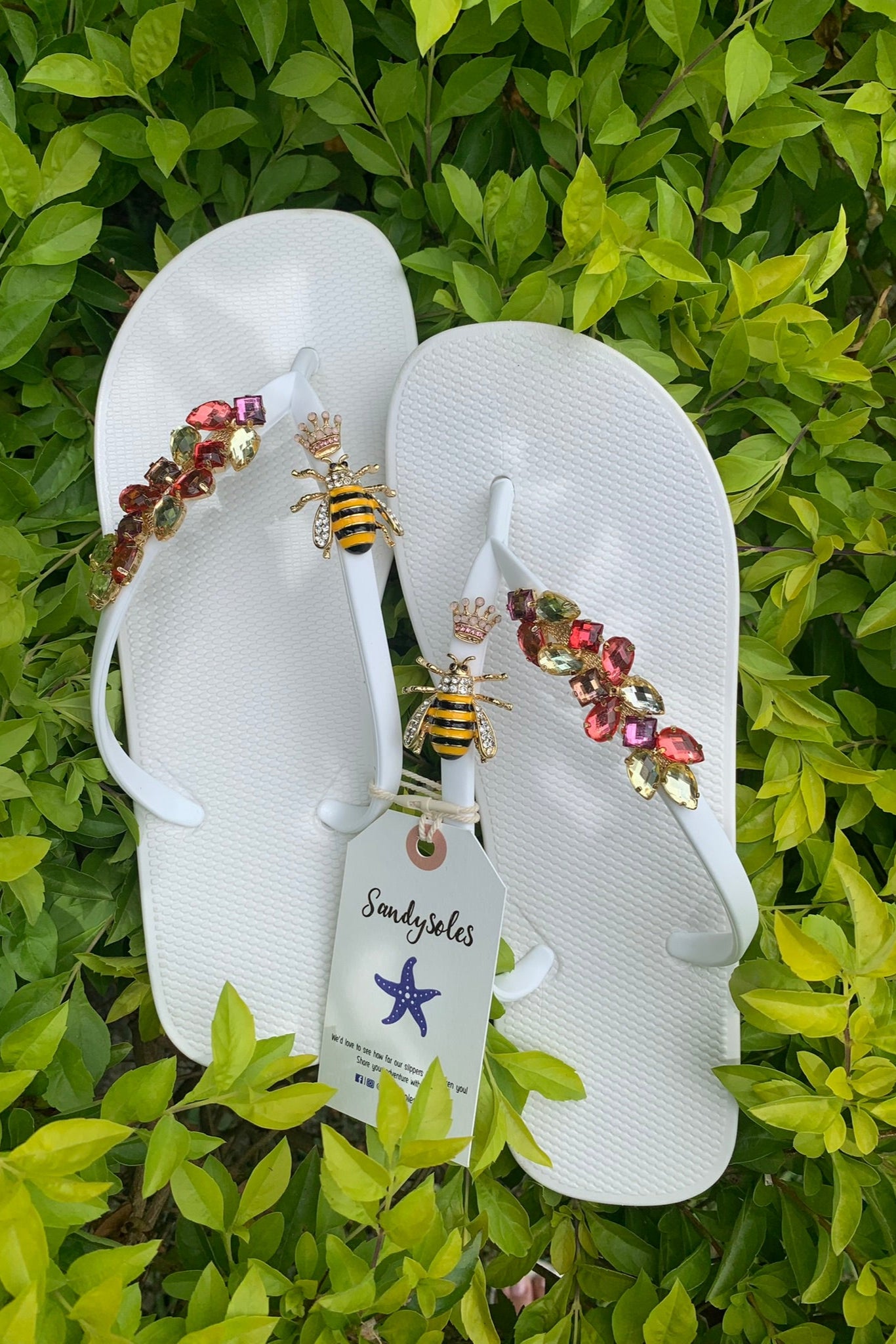 White flip-flops with decorative charms 