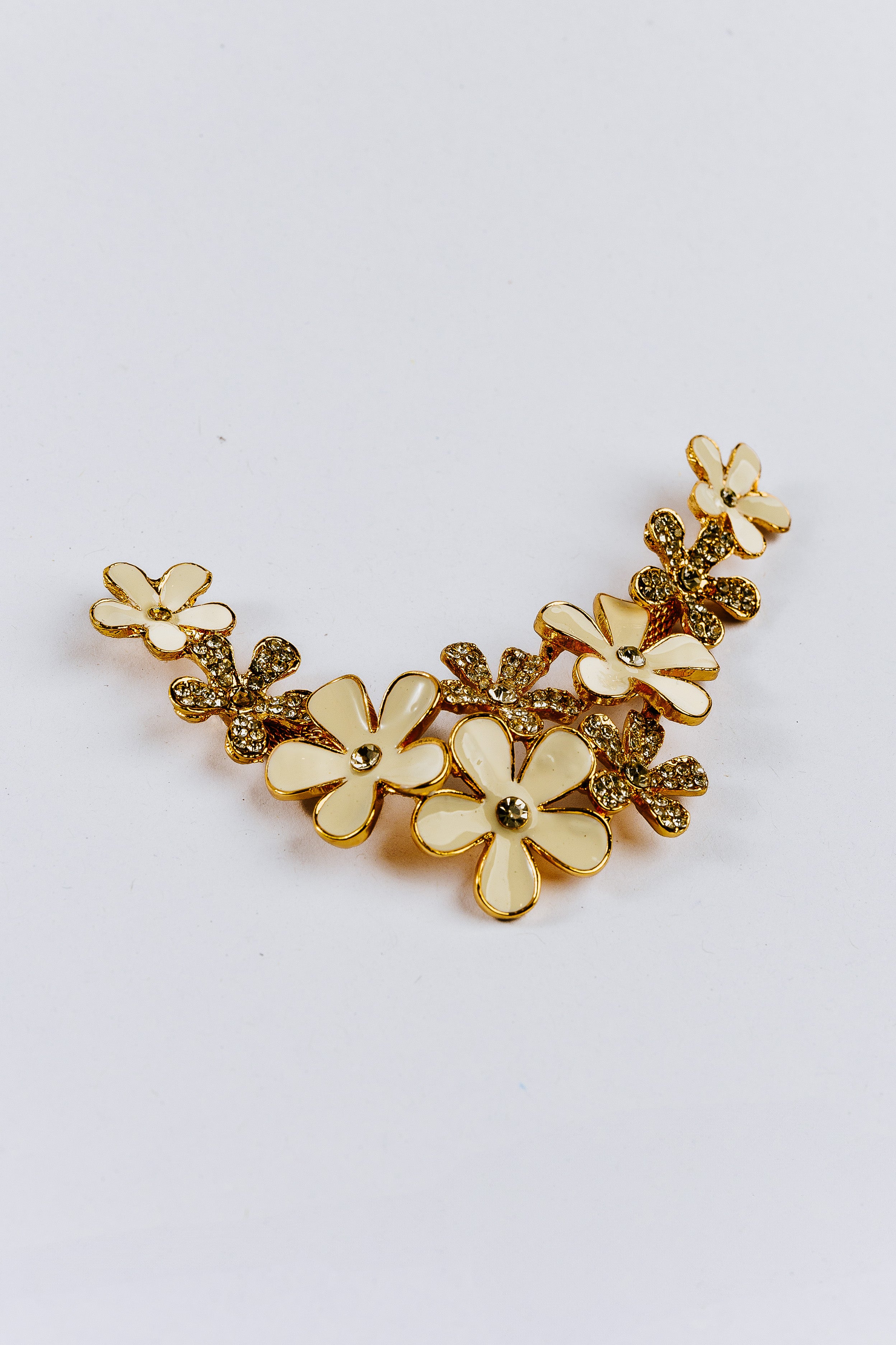 White flower arch-shaped charm with gemstones