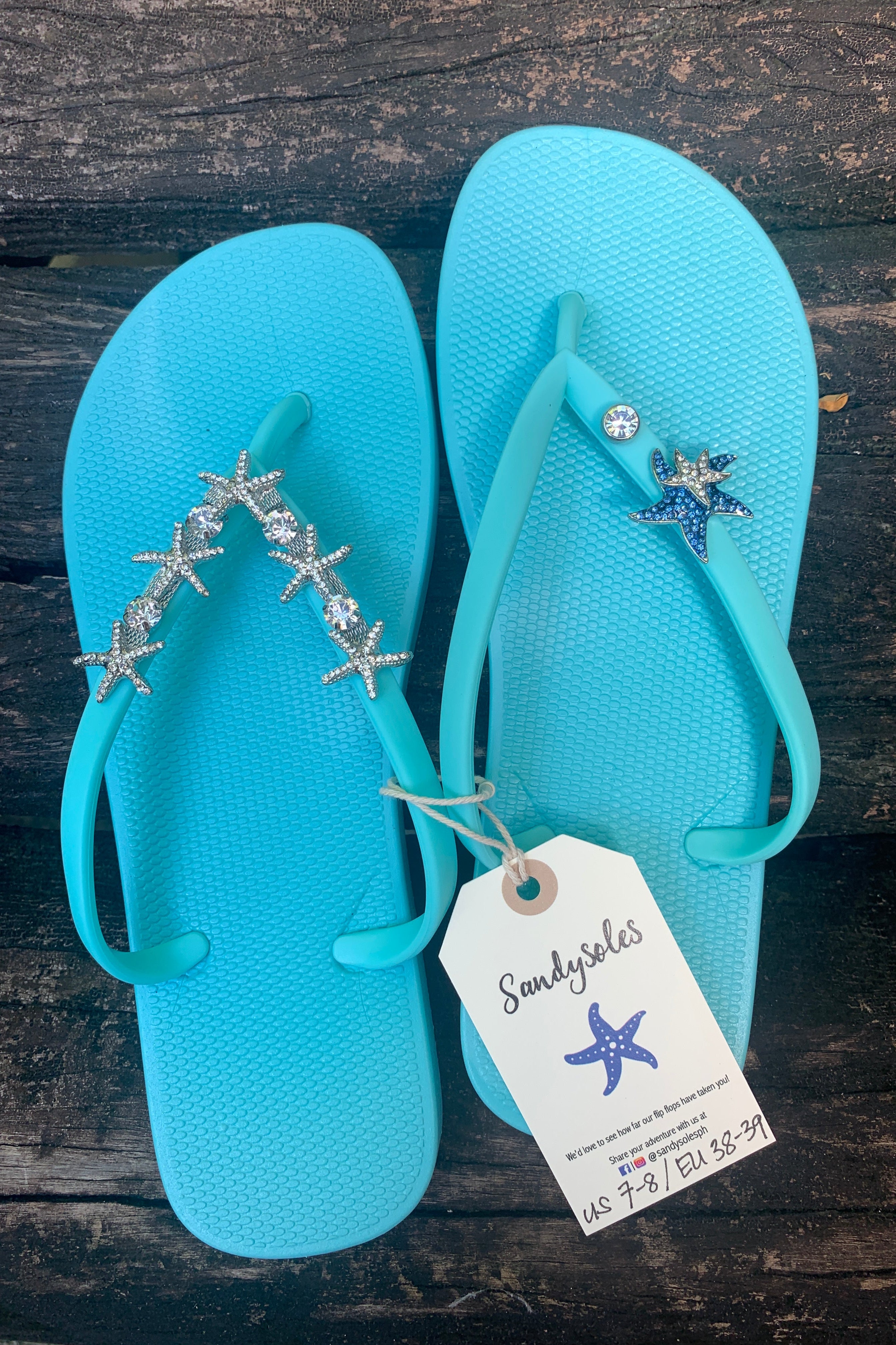 Pair of aqua flip-flops with starfish and gemstone charms 