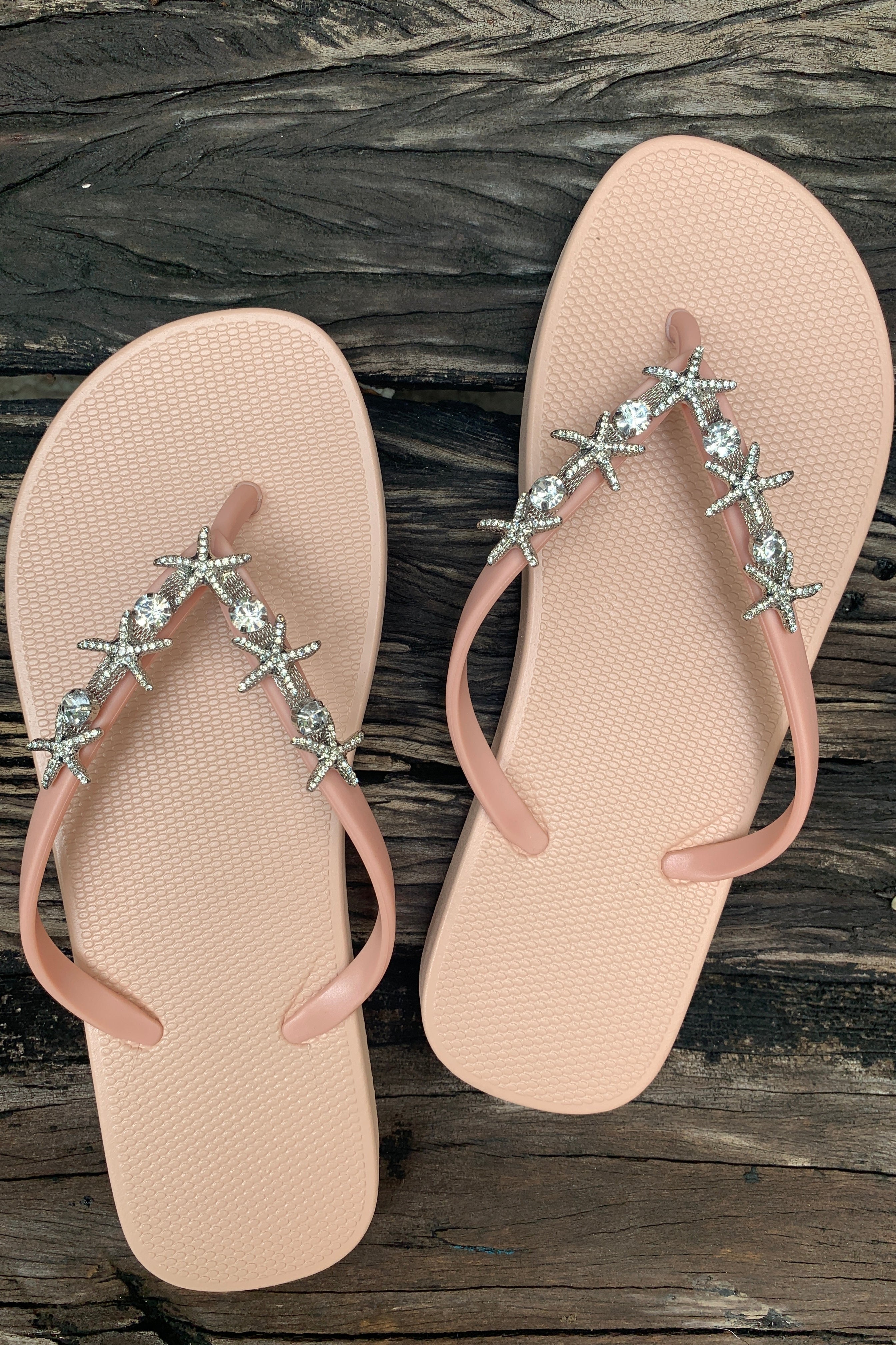 a pair of rose flip-flops with a silver twin starfish arch charm